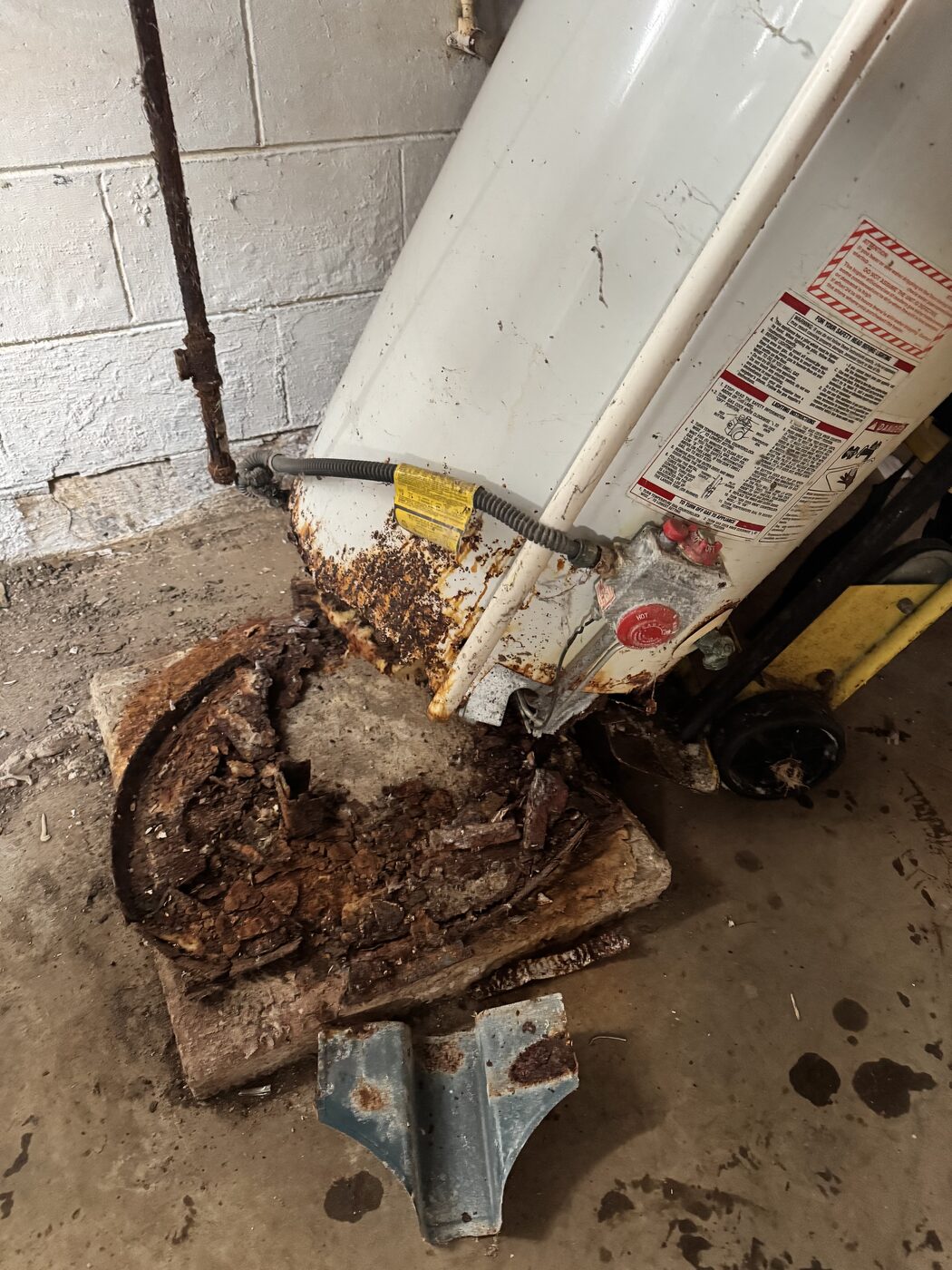Rusted water heater removed from a home